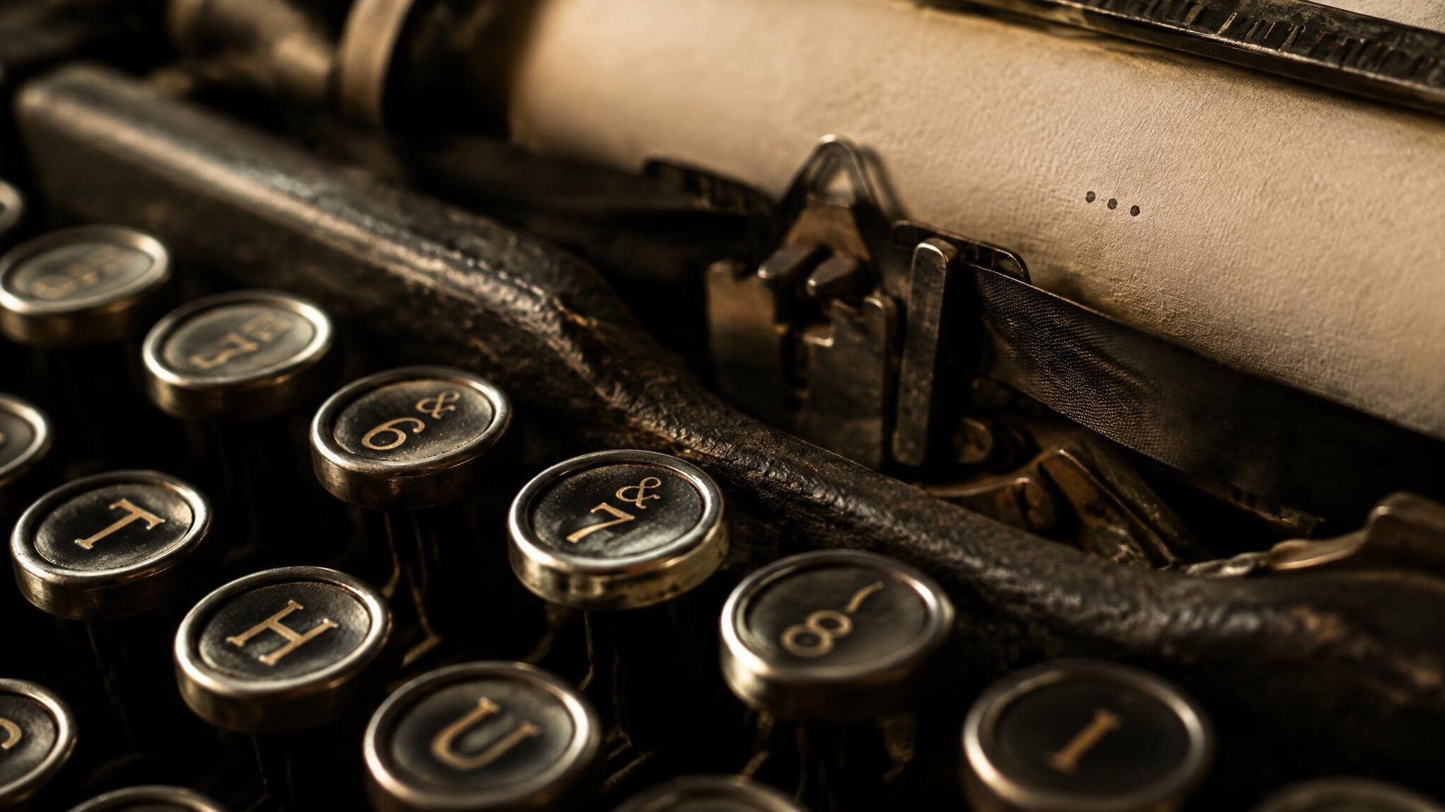Close-up of typewriter keys with a sheet of paper
